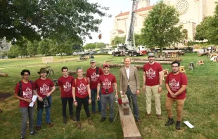 Professors and students stand in front of the Basilica of the National Shrine of the Immaculate Conception at The Catholic University of America's campus, to begin building truss number six of Notre Dame Cathedral in France. Patrick G. Ryan, university photographer